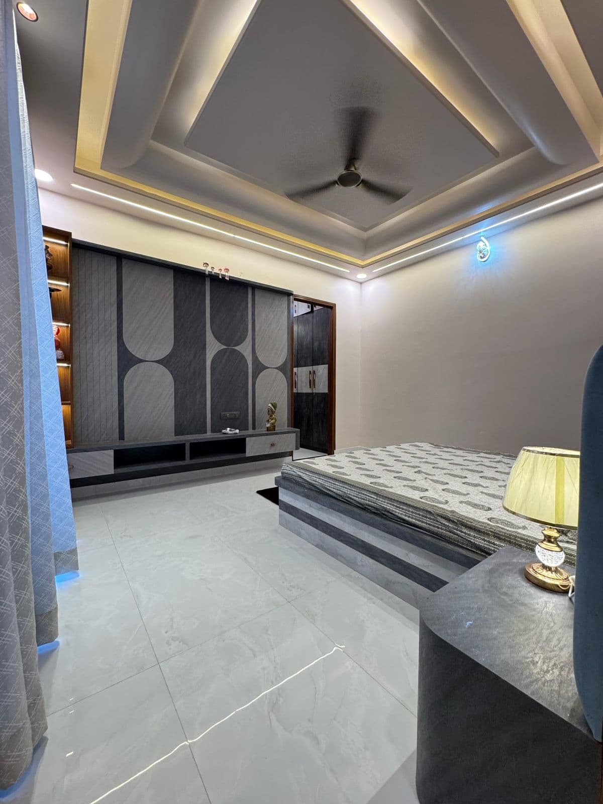 Bedroom with designer TV unit & false ceiling