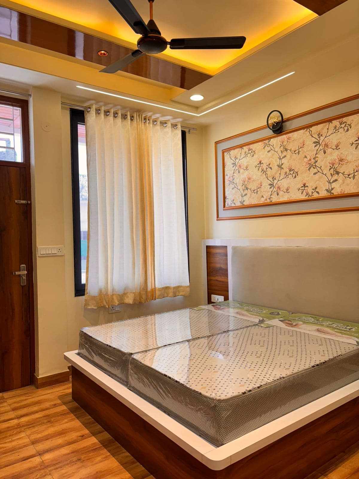 Bedroom with floral wallpaper & wooden bed frame