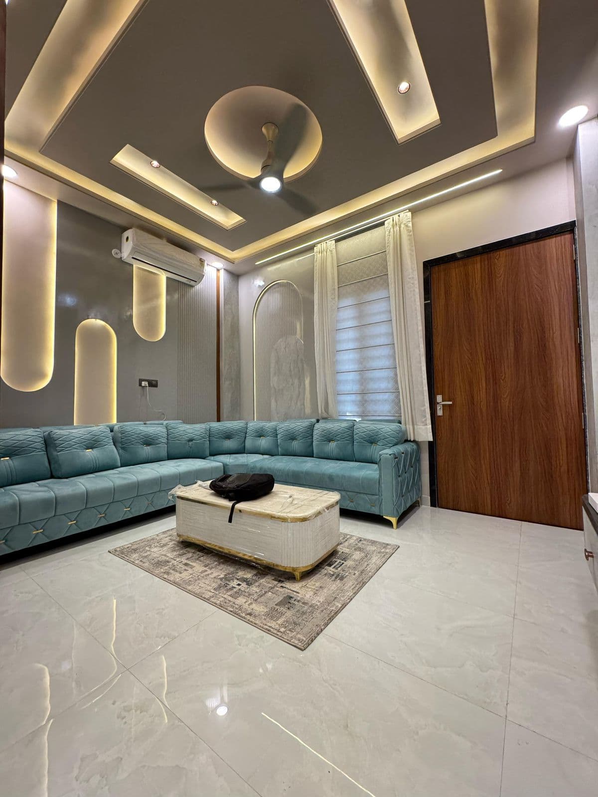 Living room with teal L-shaped designer sofa