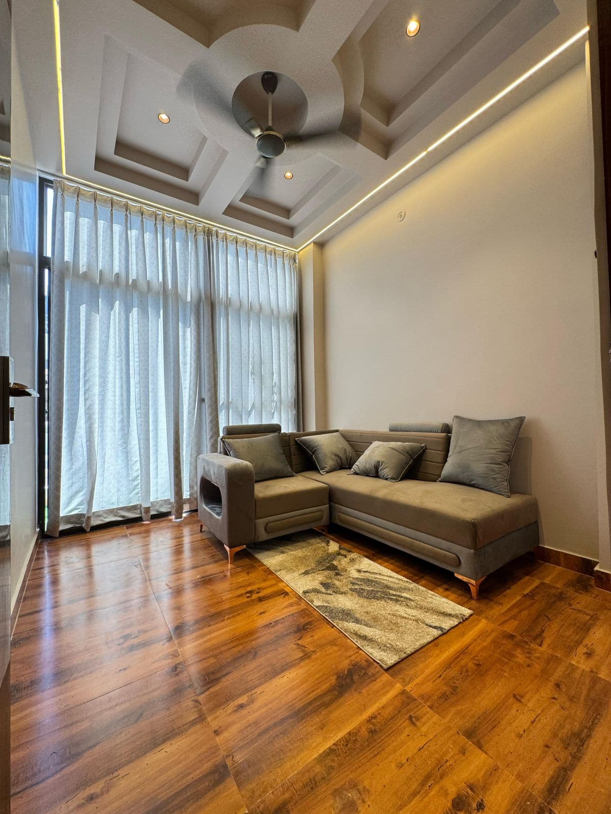 Drawing room with sofa & wooden flooring
