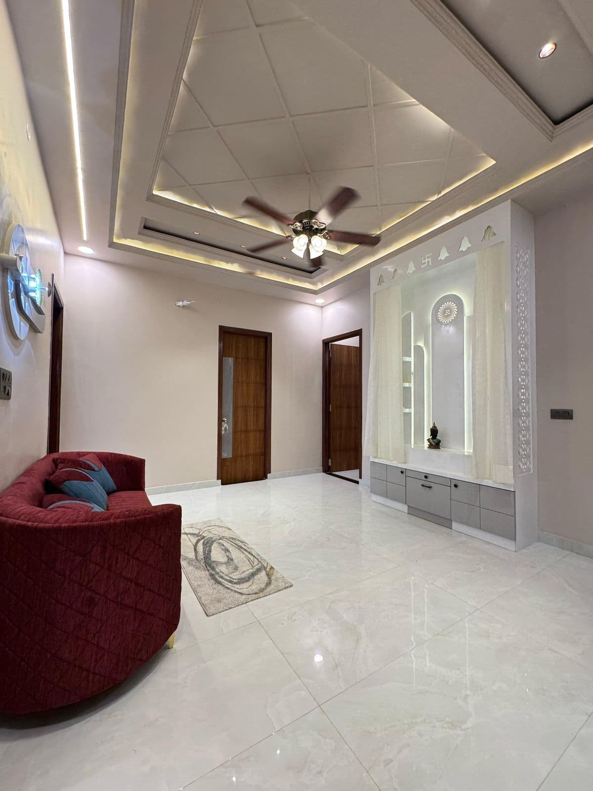 Living room with mandir, sofa & designer ceiling